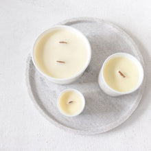 Load image into Gallery viewer, A picture of a 50cl, 30cl &amp; 9cl candle from  a birds eye view perspective, clearly showing the aesthetic of the wooden wicks  they have been made with 
