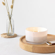 Load image into Gallery viewer, Picture of a lit 50cl candle, with double wooden wicks in a white glass vessel with MJM Home Fragrance branding 
