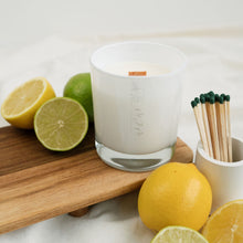 Load image into Gallery viewer, A picture of a 30cl candle with a wooden wick in a white glass vessel with MJM Home Fragrance logo.  The candle is surrounded by citrus fruits to depict the scent notes
