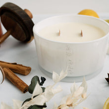 Load image into Gallery viewer, A picture of a 50cl candle surrounded by ingredients that depict the fragrance dark honey &amp; tobacco. The candle has a double wooden wick and is in a white glass vessel with MJM Home Fragrance logo
